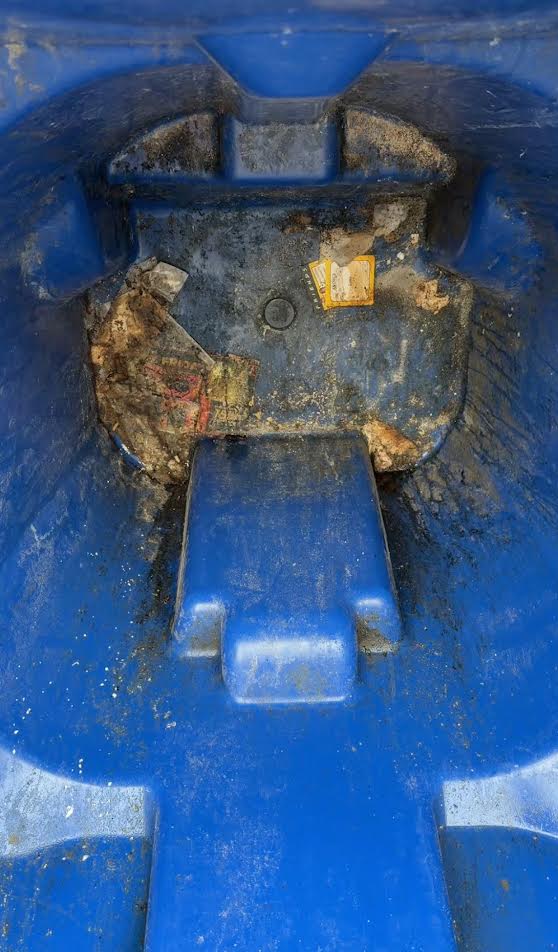 Dirty trash bin before power washing